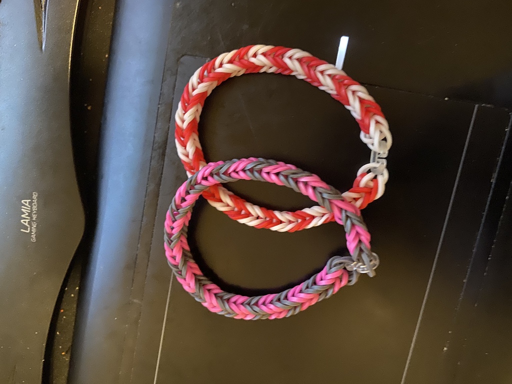 Pink and grey rubber band bracelet and red and white rubber band bracelet
