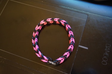 black and pink rubber band bracelet